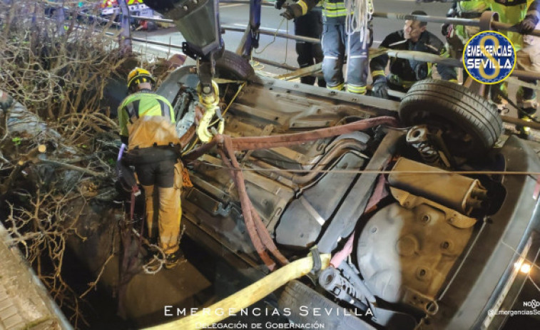 Rescatan a cuatro jóvenes de un coche suspendido a siete metros en Sevilla