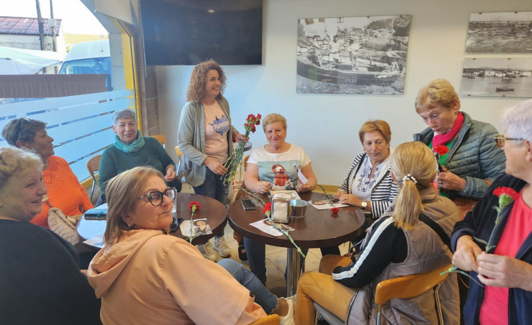 La candidata socialista de Vilanova departe con los vecinos en un reparto de claveles en el mercado