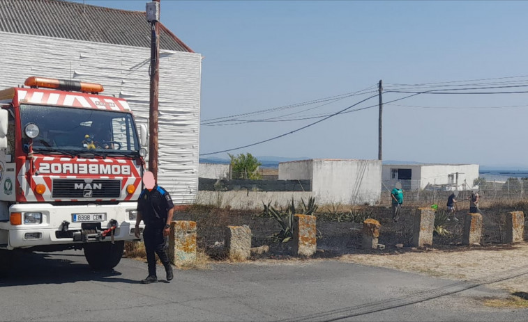 Declarado un incendio forestal en una finca privada próxima a viviendas y a una pasarela de madera en Ribeira
